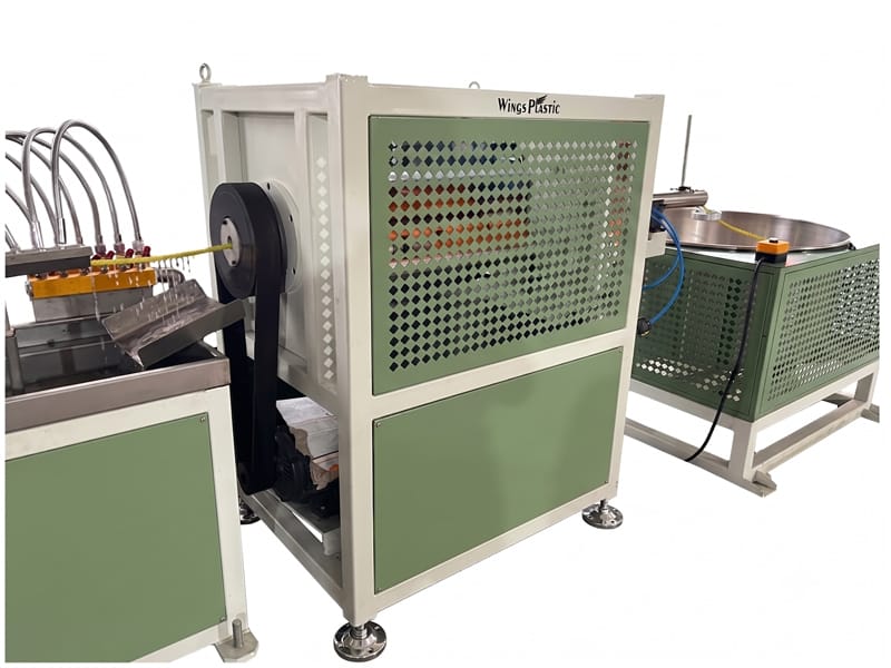 Rotary haul-off and cutting unit for spiral wrap protector line