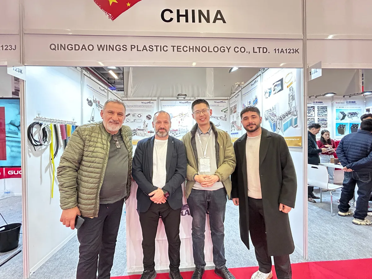 Wings Plastic team at exhibition showcasing corrugator machines